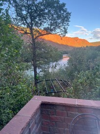 View from patio of Rifle river. Short walk to river’s walking/ bike path.