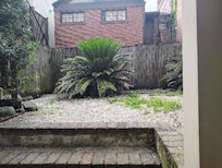 The back courtyard. Notice the weeds.