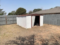 The old broken shed in the corner of the backyard. I wasn't sure what or who might be in there, with the unlocked back gate and the SWAT stand off going on across the alley.