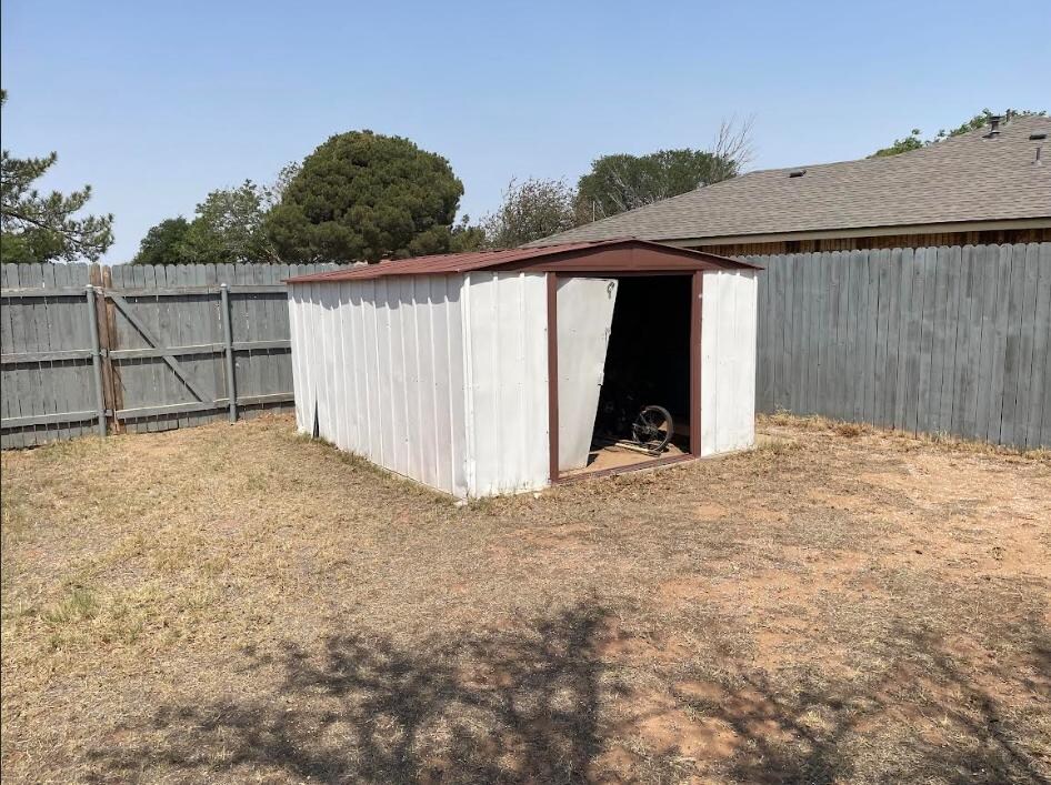 The old broken shed in the corner of the backyard. I wasn't sure what or who might be in there, with the unlocked back gate and the SWAT stand off going on across the alley.