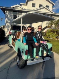Our awesome golf cart in front of the house, rented from AMI beach bum