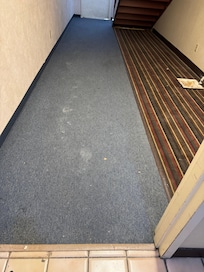 Broken drywall pieces on the floor of the main hallway.