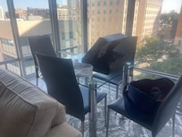 Furniture of wrong proportion for the living room; even the tiniest, inadequate dining table is wedged in and uncomfortable.