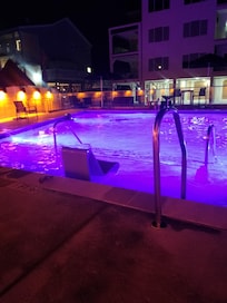 There's a picture of a beautiful pool lit up at night