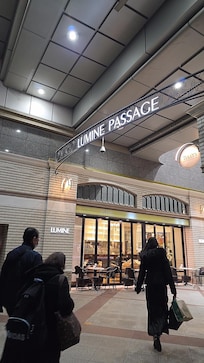 Exit the entrance opposite the front lobby and you will see the shopping center right in front of you.