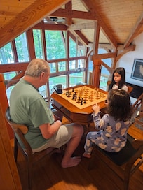 Chess board table overlooking the lower level with a view of the lakeeaten by a 7 year