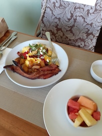 Best fluffy scrambled eggs with savory Mediterranean toppings, lovely potatoes, super crispy & thick bacon, and fresh fruit!  Yum!  The locally roasted coffee was excellent, too!