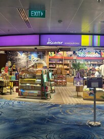 Walk to the right of this store, & go up the escalator!