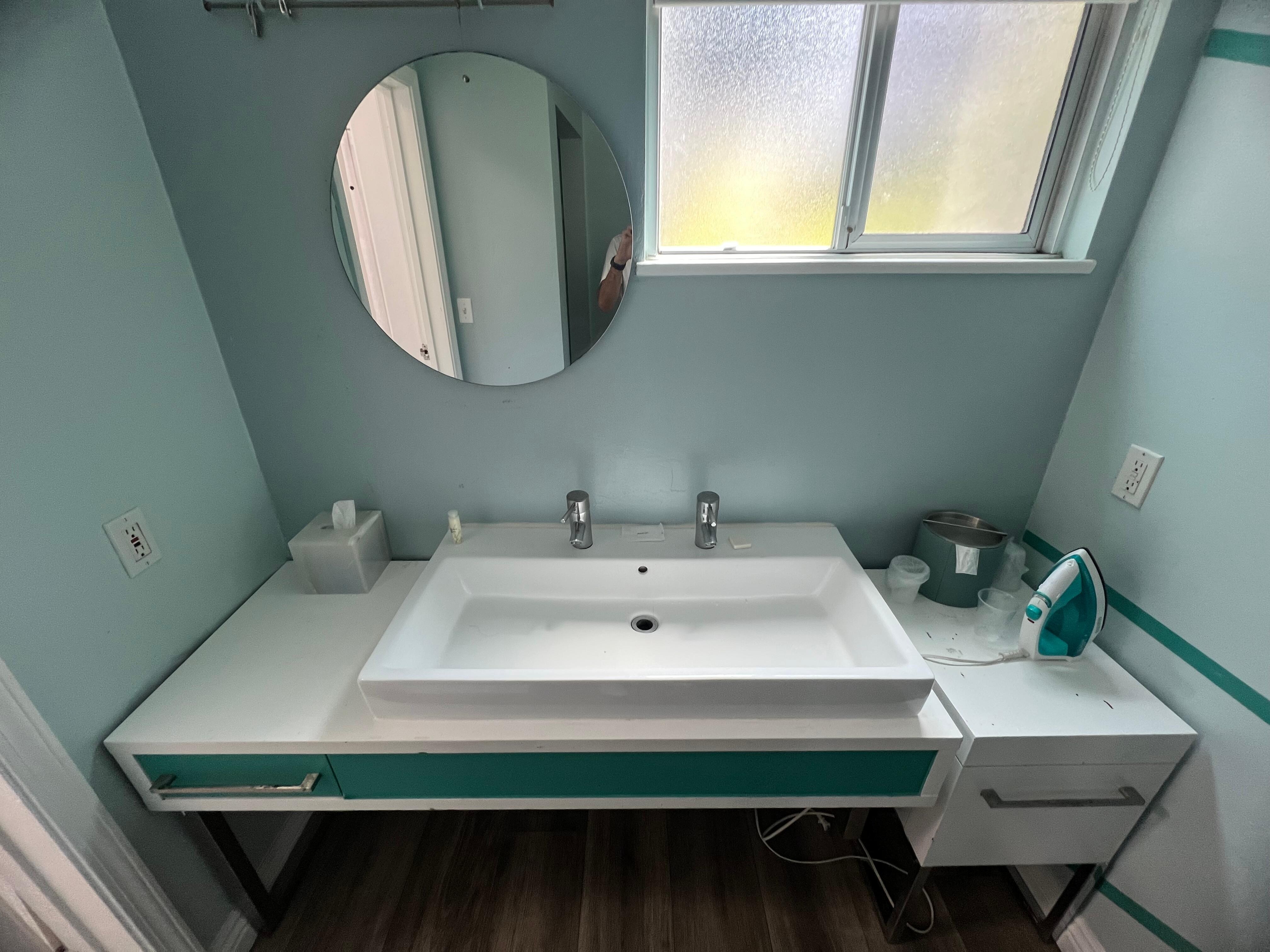 Sink was dirty with the vanity mirror hanging by one type of string. Really?