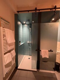 One sliding door between shower and bathroom