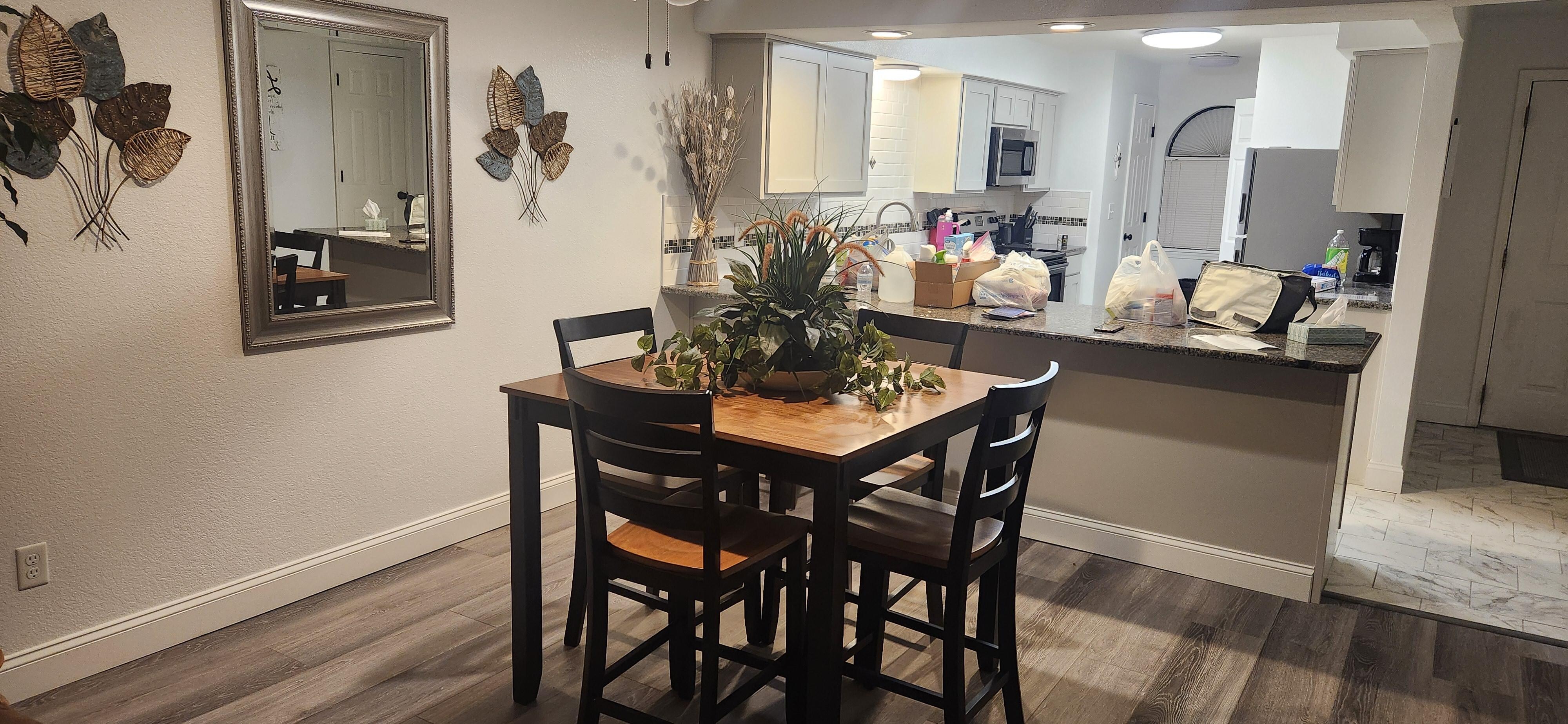 The Dining and Kitchen area. Two barstools are provided too. The Dining table chairs can also work for the bar because the barstools aren't sturdy for larger body frames.