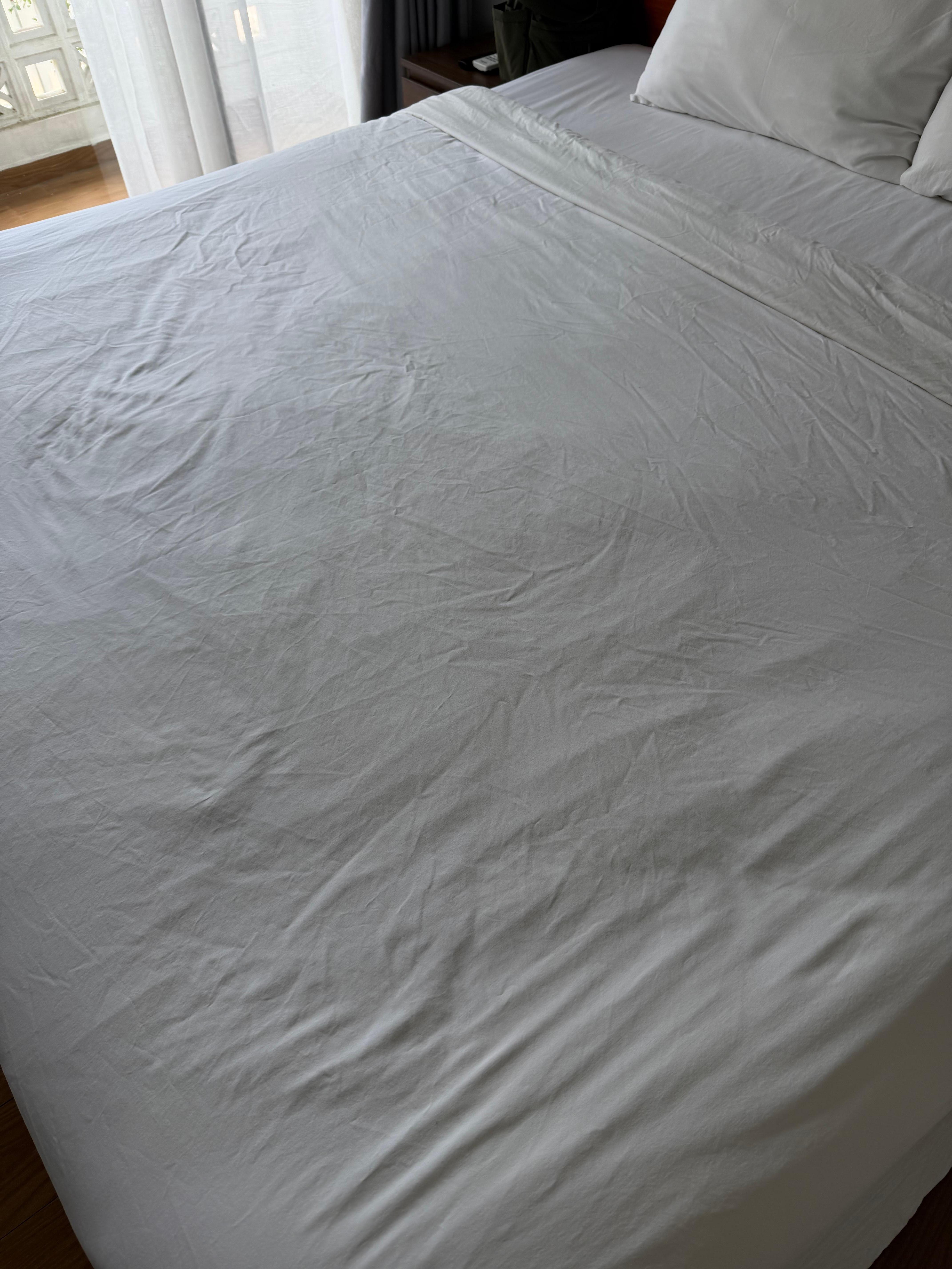 The bed sheets are old and stained.