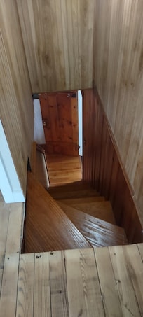 The stairs going up to the bedrooms are steep and narrow. They end in a bedroom without a door, and you have to go through this bedroom to get to the main bedroom.