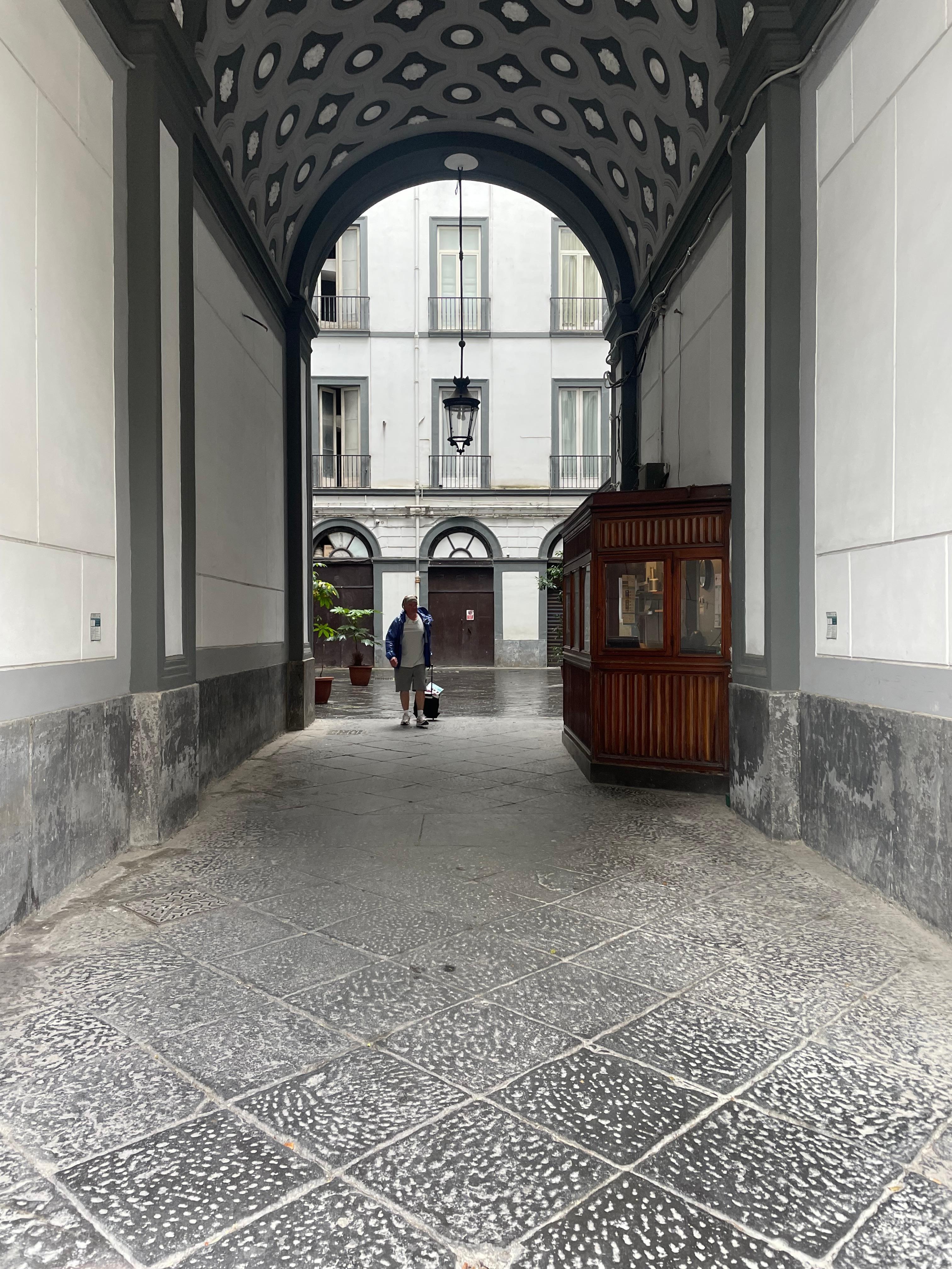 The entrance from the street. This is concealed by a traditional huge wooden door which is opened at certain points during the day by the friendly caretaker for the building. The entrance to Antica Dimora Pessina is on the left of the courtyard.