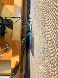 Plug sockets occupied by minibar and TV with exposed rear wiring. As a qualified electrician, I can’t stress enough how dangerous this is and should be rectified accordingly.