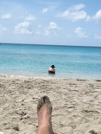 Reading her book on water's edge