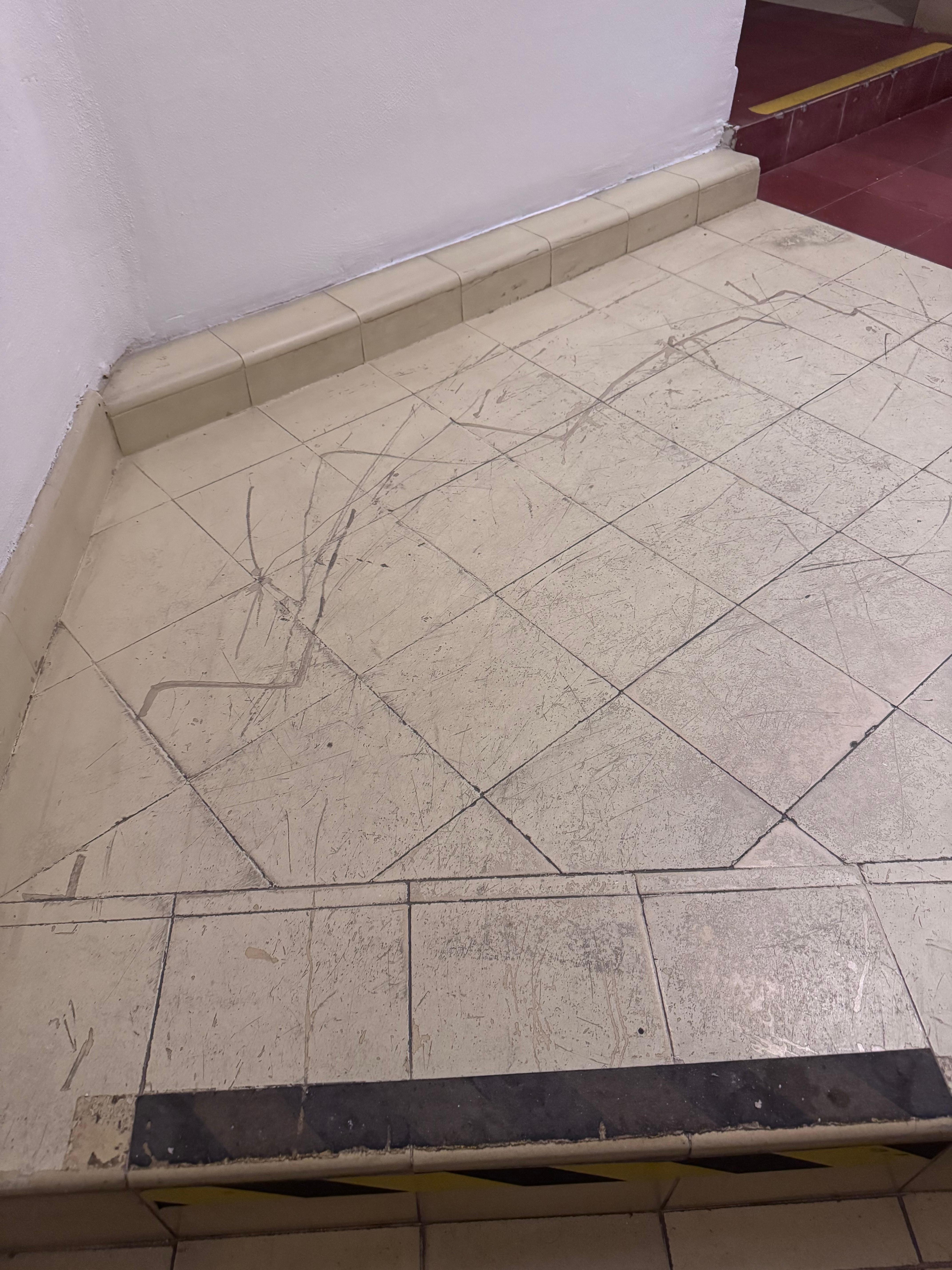 Dirty and damaged stairways, those are yellow caution stickers that have gone black from filth