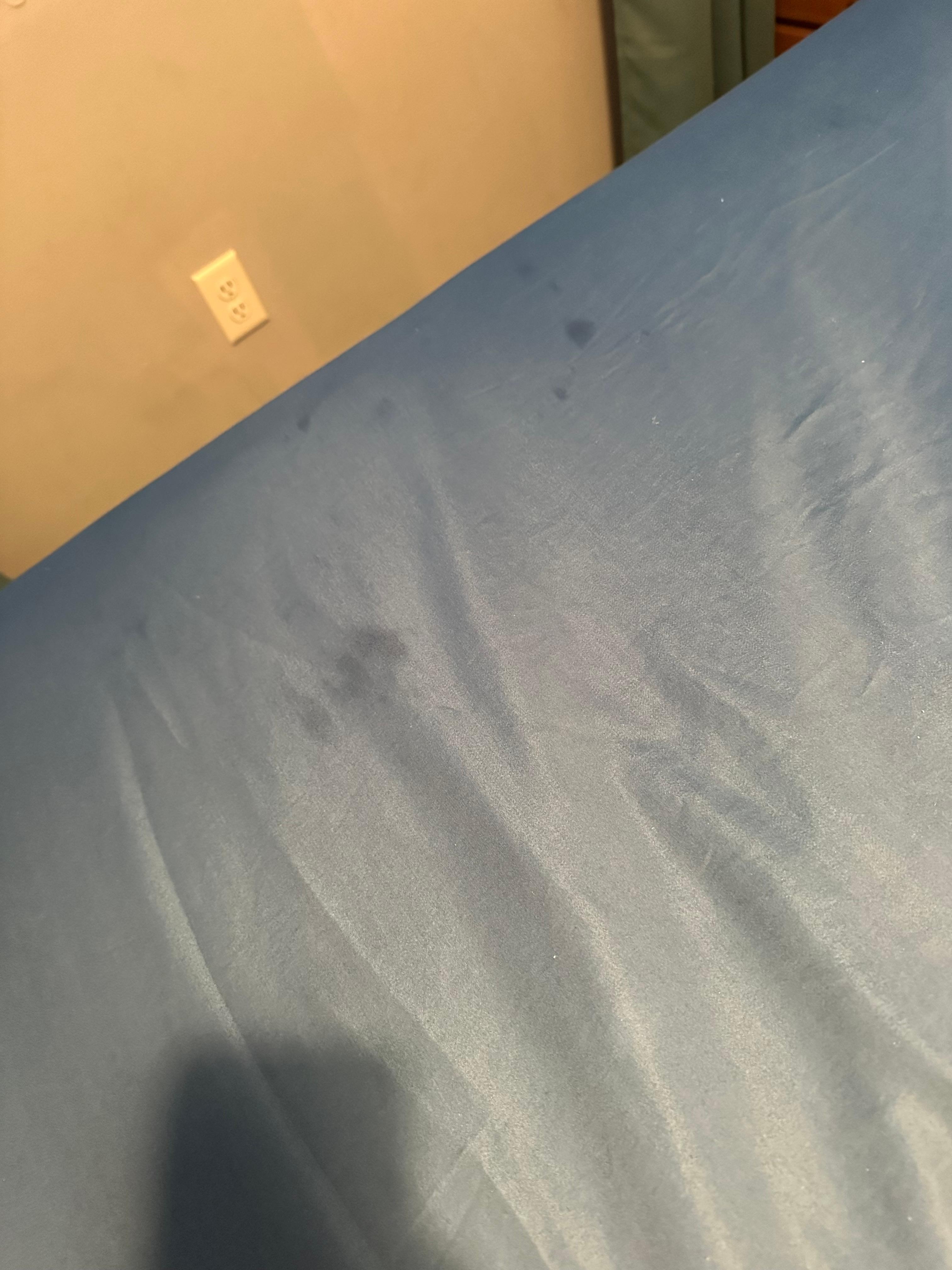 Stains on the fitted sheet.