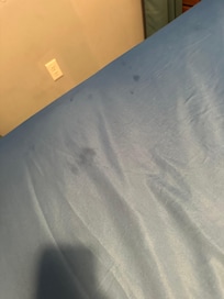 Stains on the fitted sheet.
