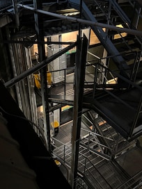Laundry carts plus bins on fire escape of two upper floors.