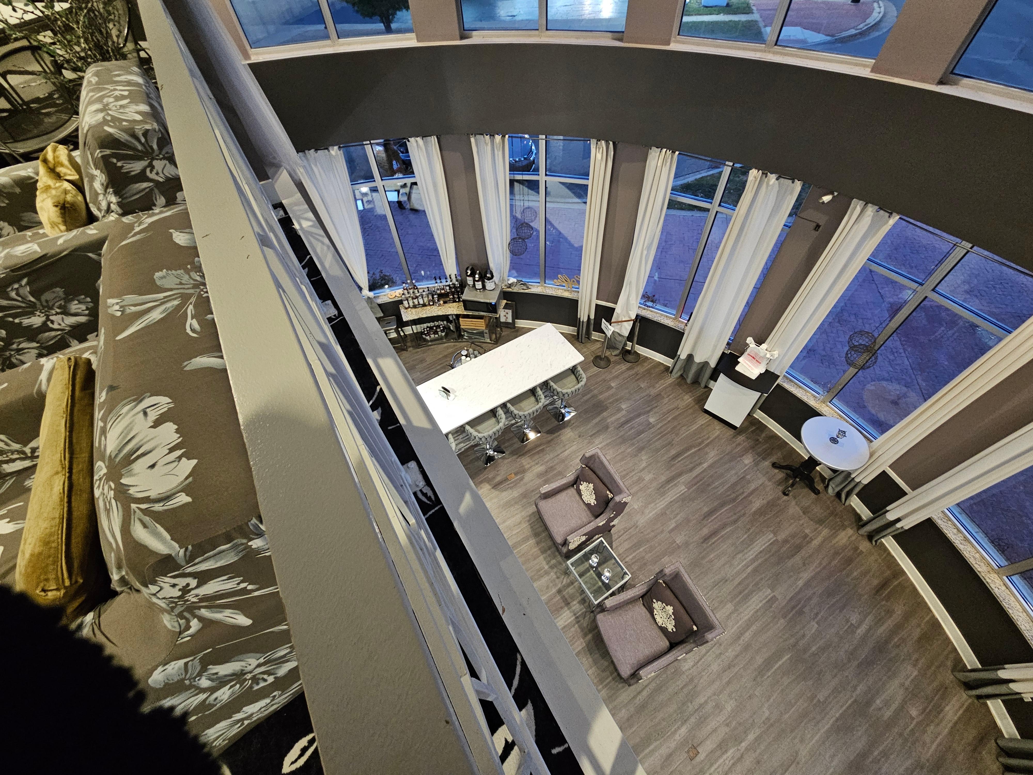 Balcony overlooking bar below and windows facing front of hotel.