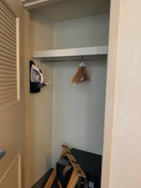 Huge closet with luggage rack and iron and board
