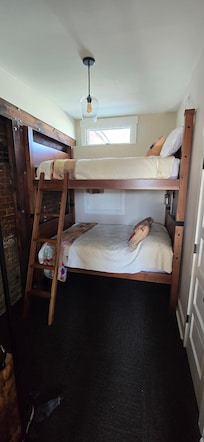 Jack and Jill bedrooms, both have full sized mattresses with a shared bathroom. The only access to upstairs is a narrow spiral staircase.