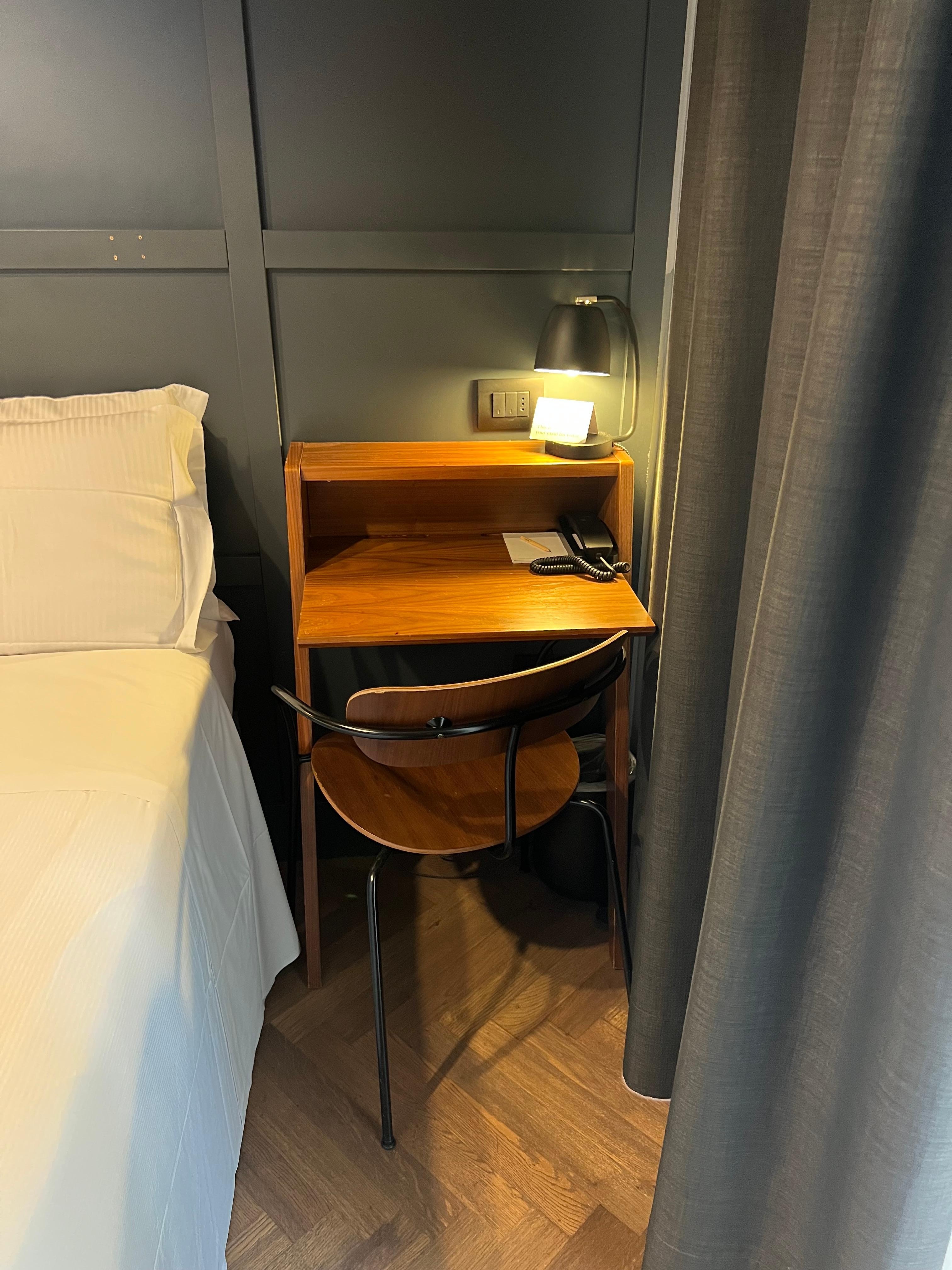 There is a small balcony through the drapes on the right with a table and two chairs.