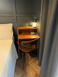 There is a small balcony through the drapes on the right with a table and two chairs.