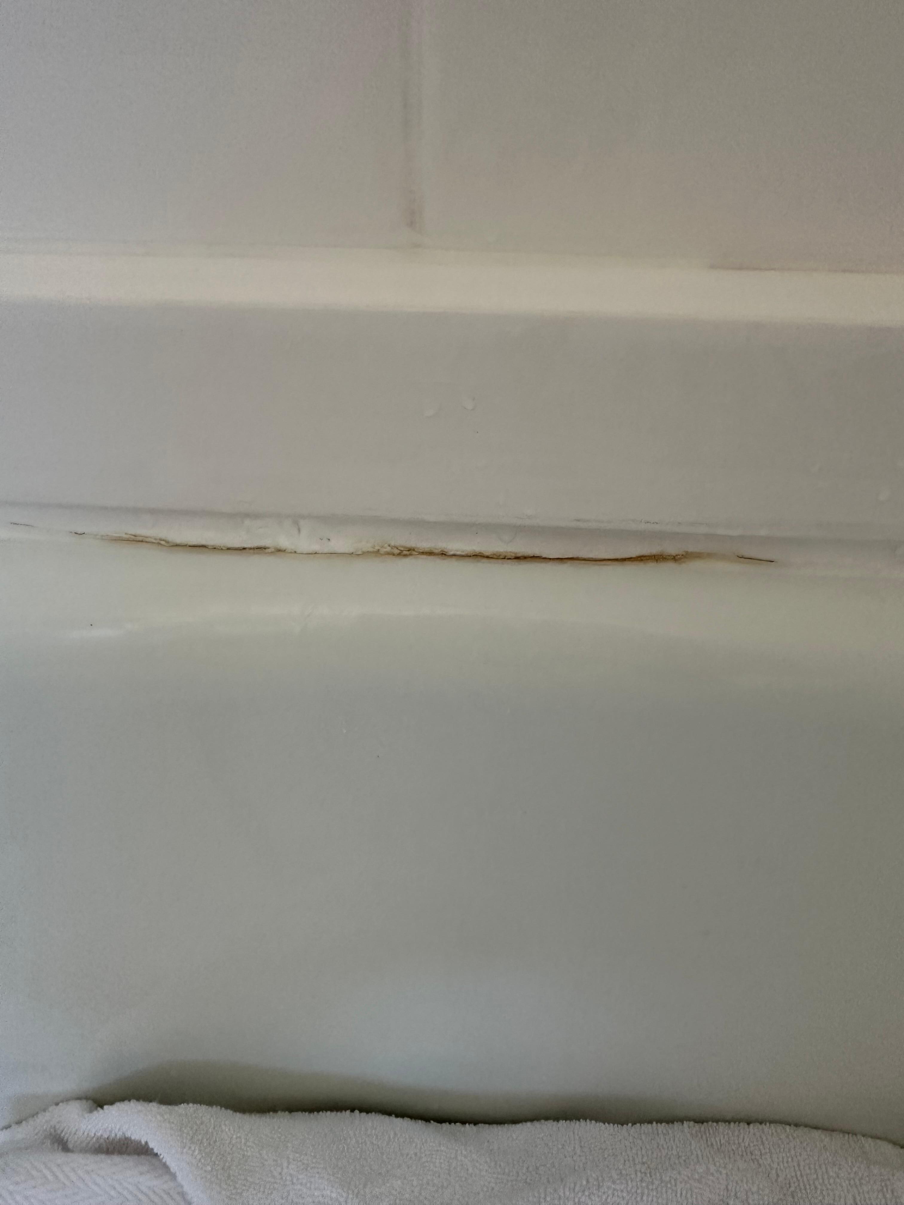 Shiwer has painted wood against the tiles and tub