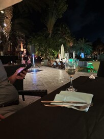 Hard to read menu as no lighting and in background a broken pool umbrella never fixed or removed while we were there for 4 weeks.