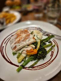 Fresh salmon dinner with risotto and vegetables at the hotel restaurant