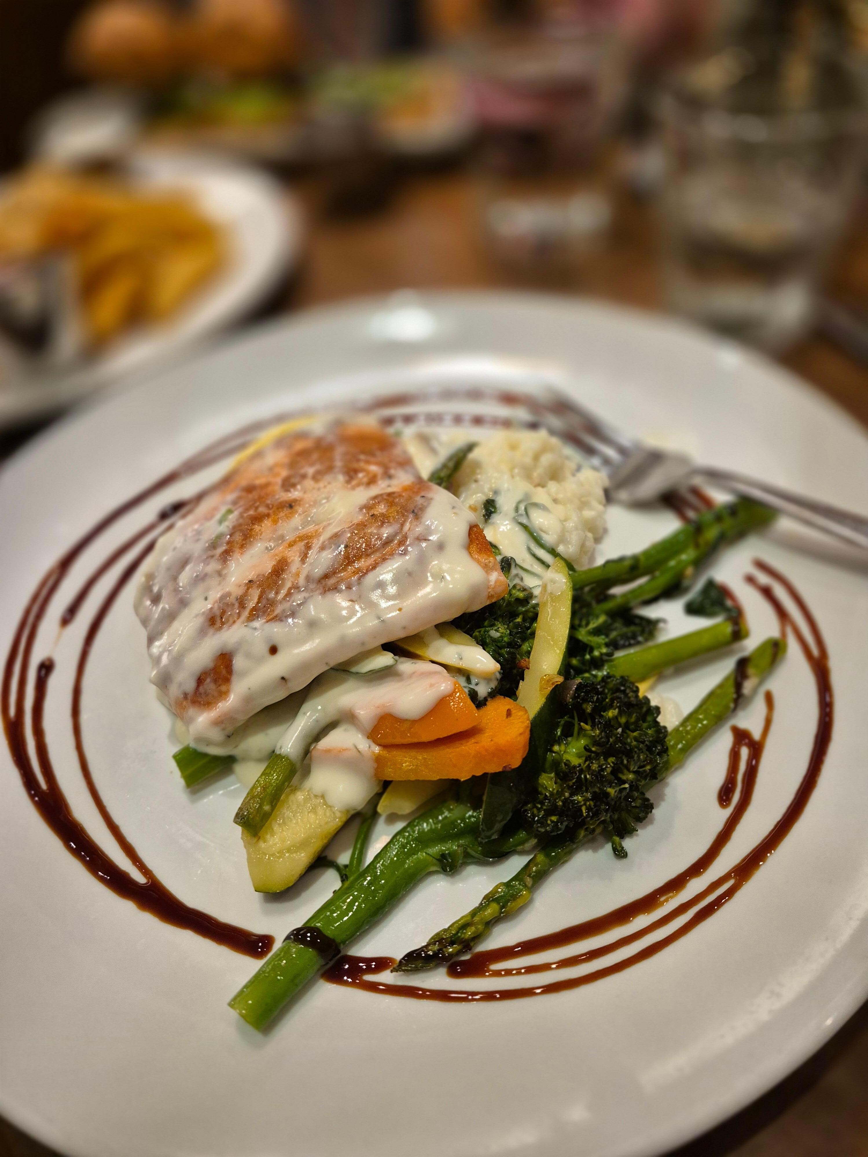 Fresh salmon dinner with risotto and vegetables at the hotel restaurant 