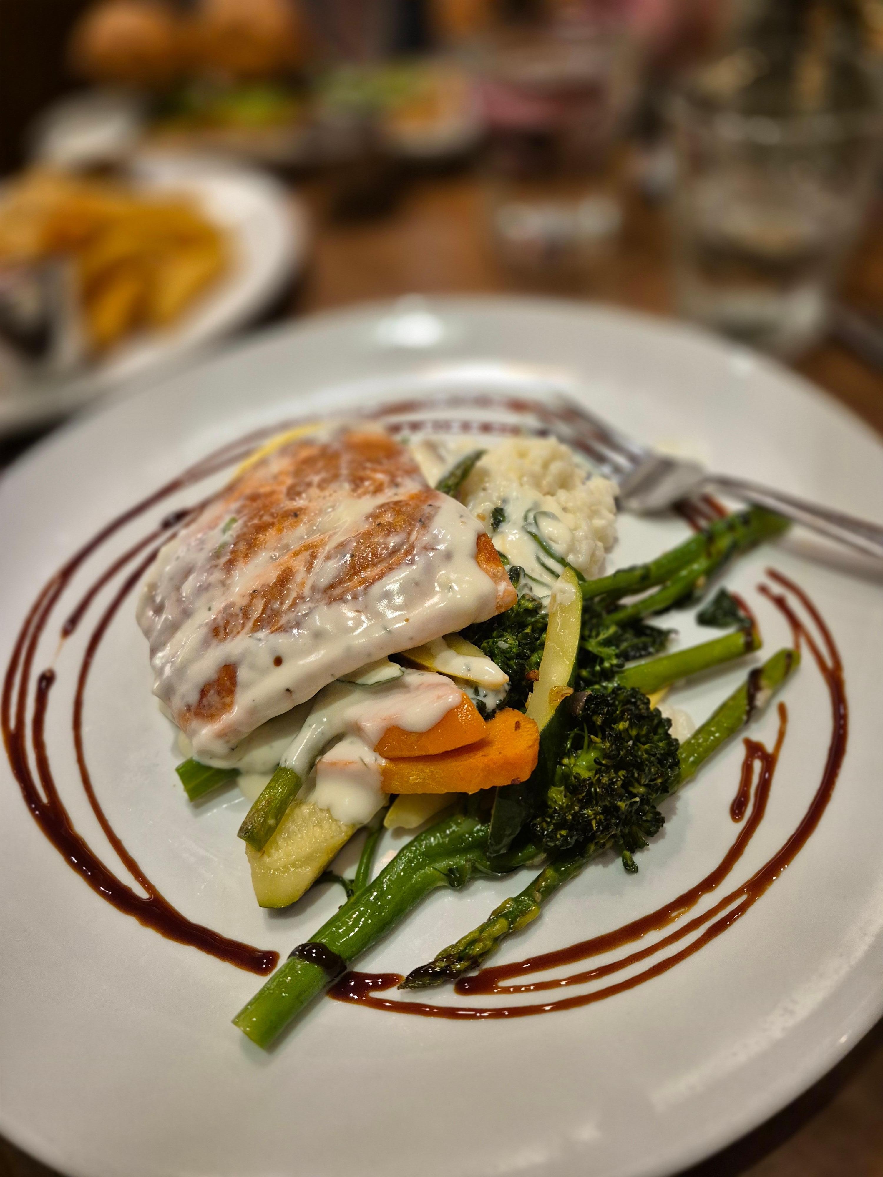 Fresh salmon dinner with risotto and vegetables at the hotel restaurant