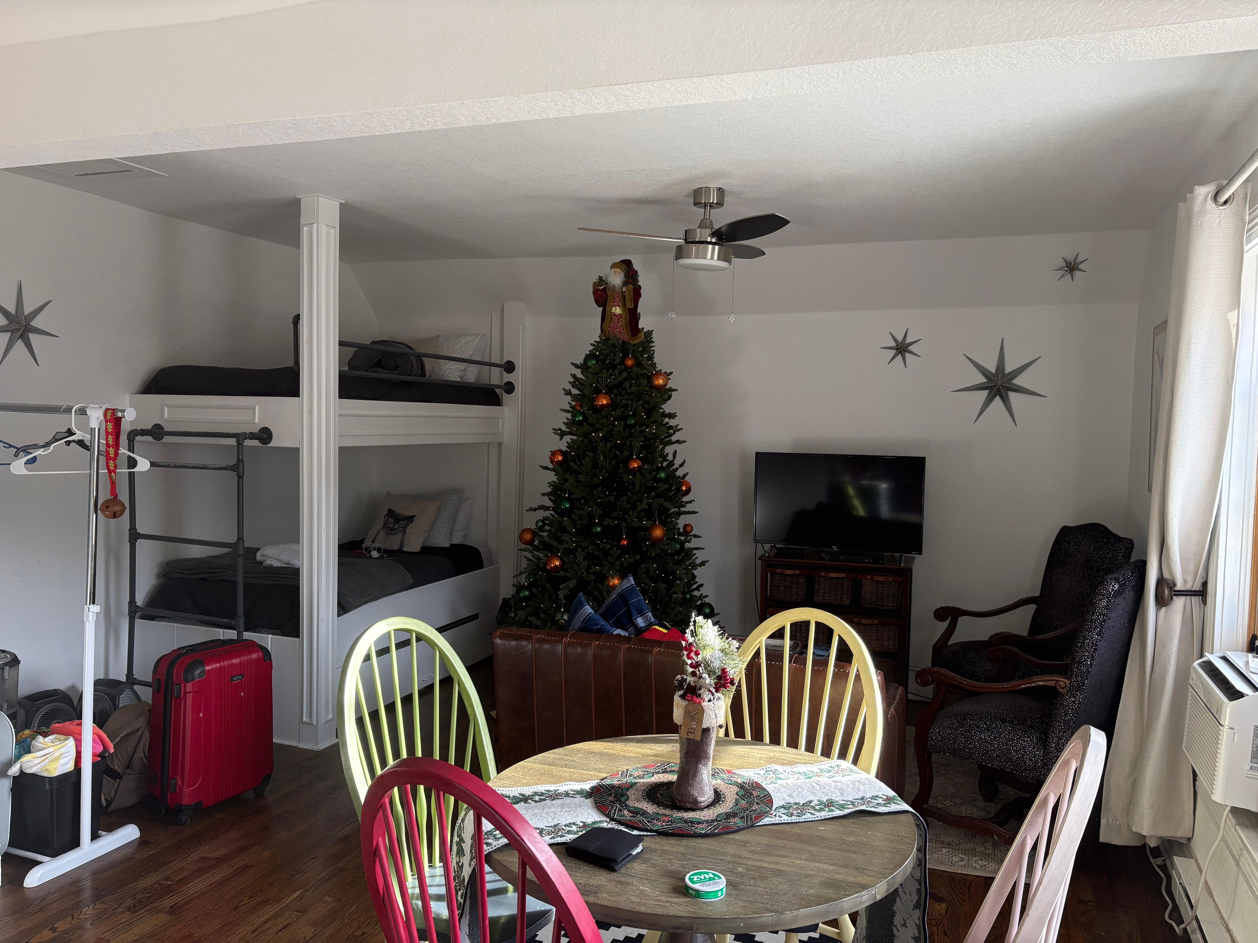 Open concept living room with bunk beds and kitchen area