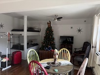 Open concept living room with bunk beds and kitchen area
