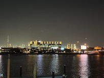 City skyline at night with occasional yachting