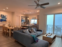 2nd floor: Living room, dining room, kitchen, and small balcony with outdoor dining set