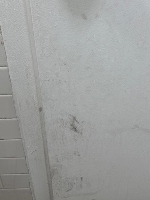 Walls and doors are dirty and unkempt.