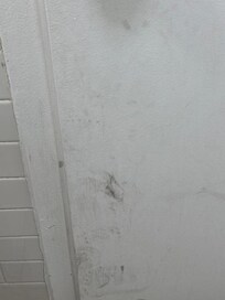 Walls and doors are dirty and unkempt.