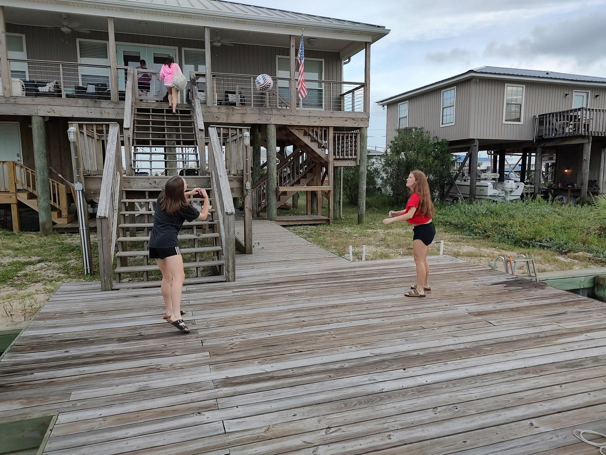 Our girls playing volleyball on the dock