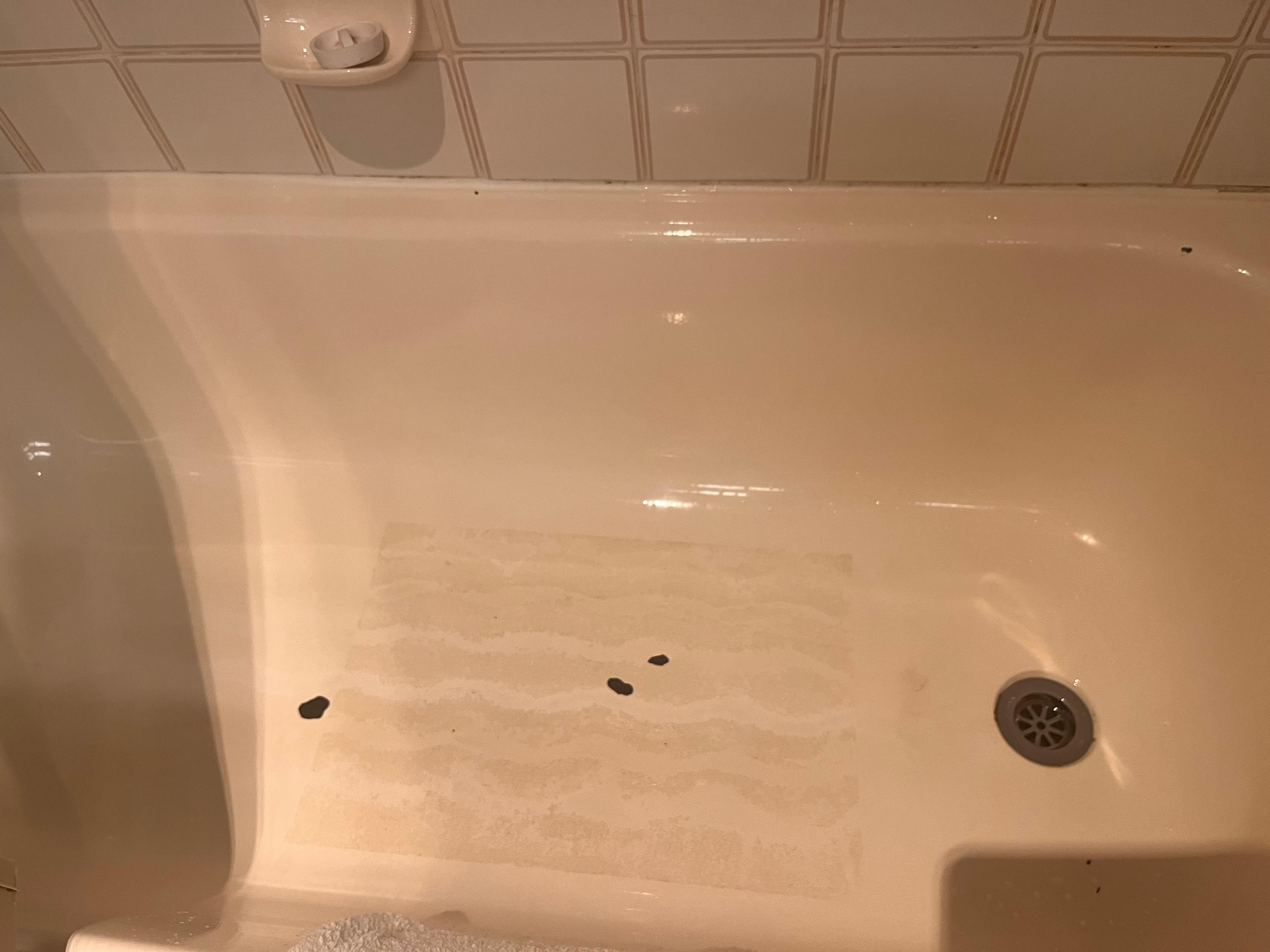 Paint peeling in tub and old bath mat stain 