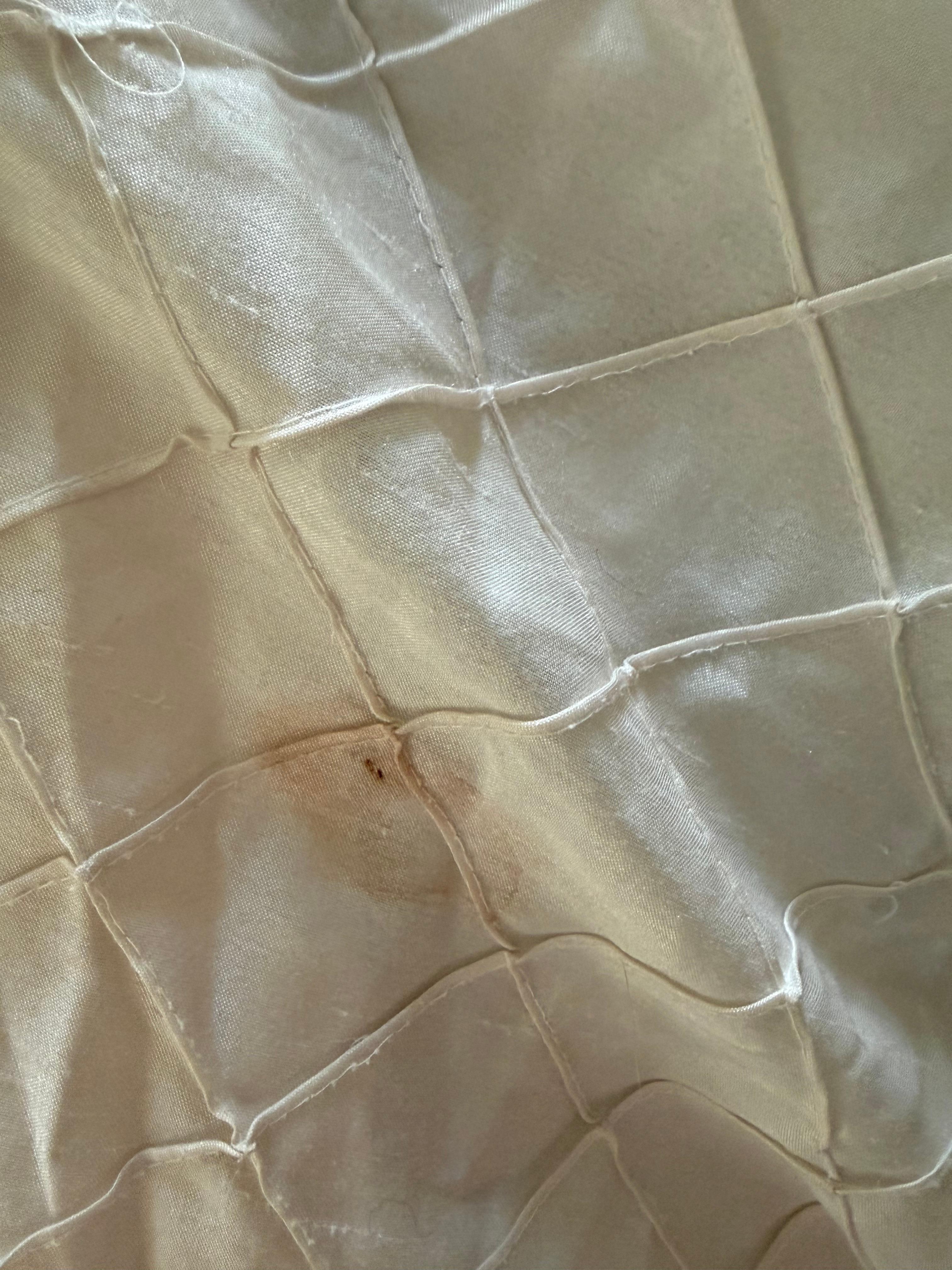 Blood stains on the bedsheets.