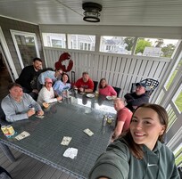 Card games on the screened-in porch at the HUGE table.