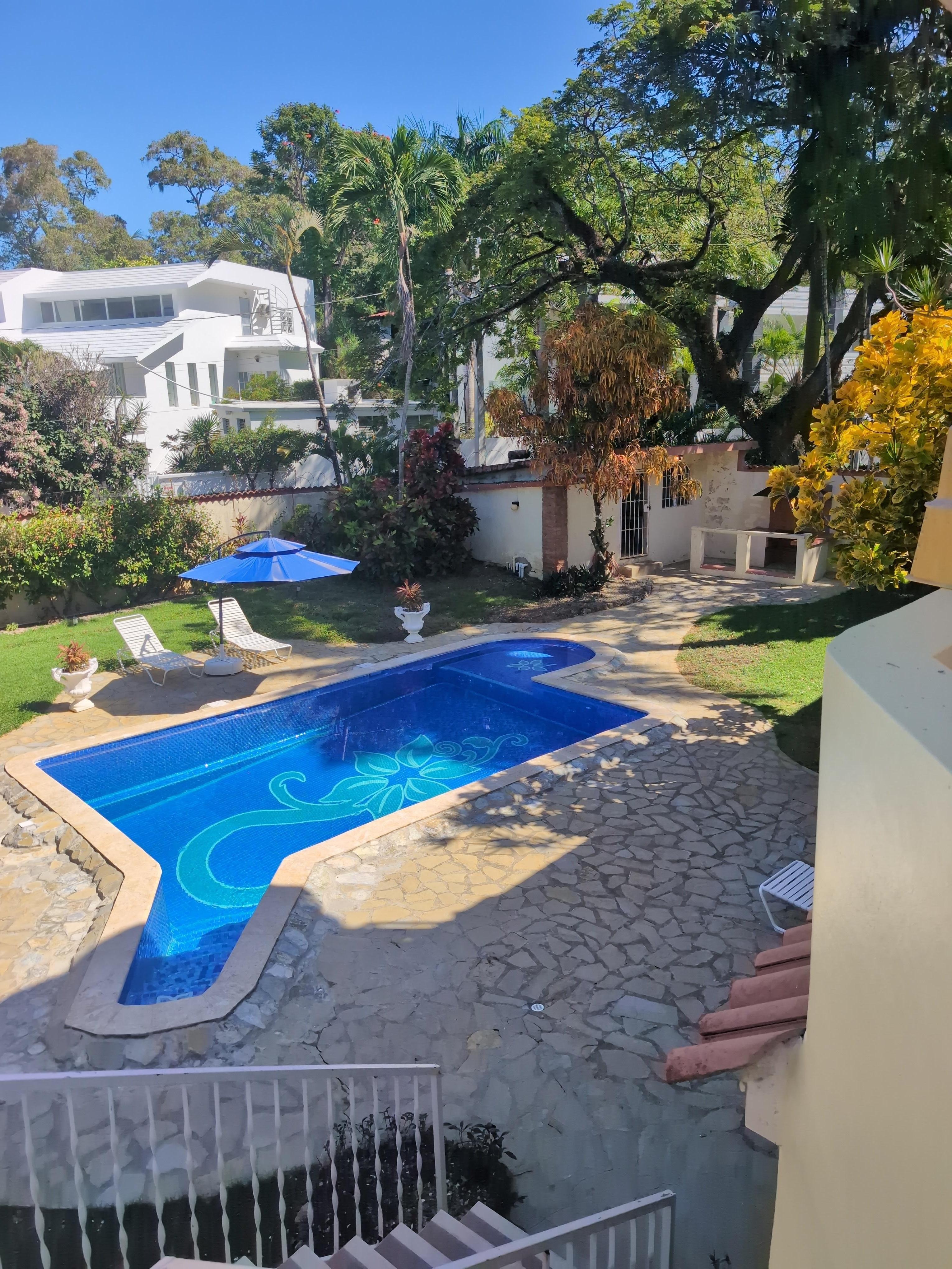 View of pool and yard from patio.