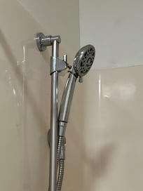 Shower head held by a wire