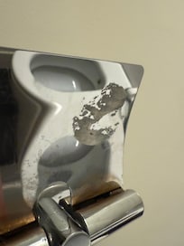 Marked underside of toilet roll holder