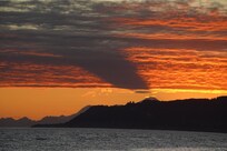 Sunset from the beach across the street. (Shadow is from one of the large mountains.)