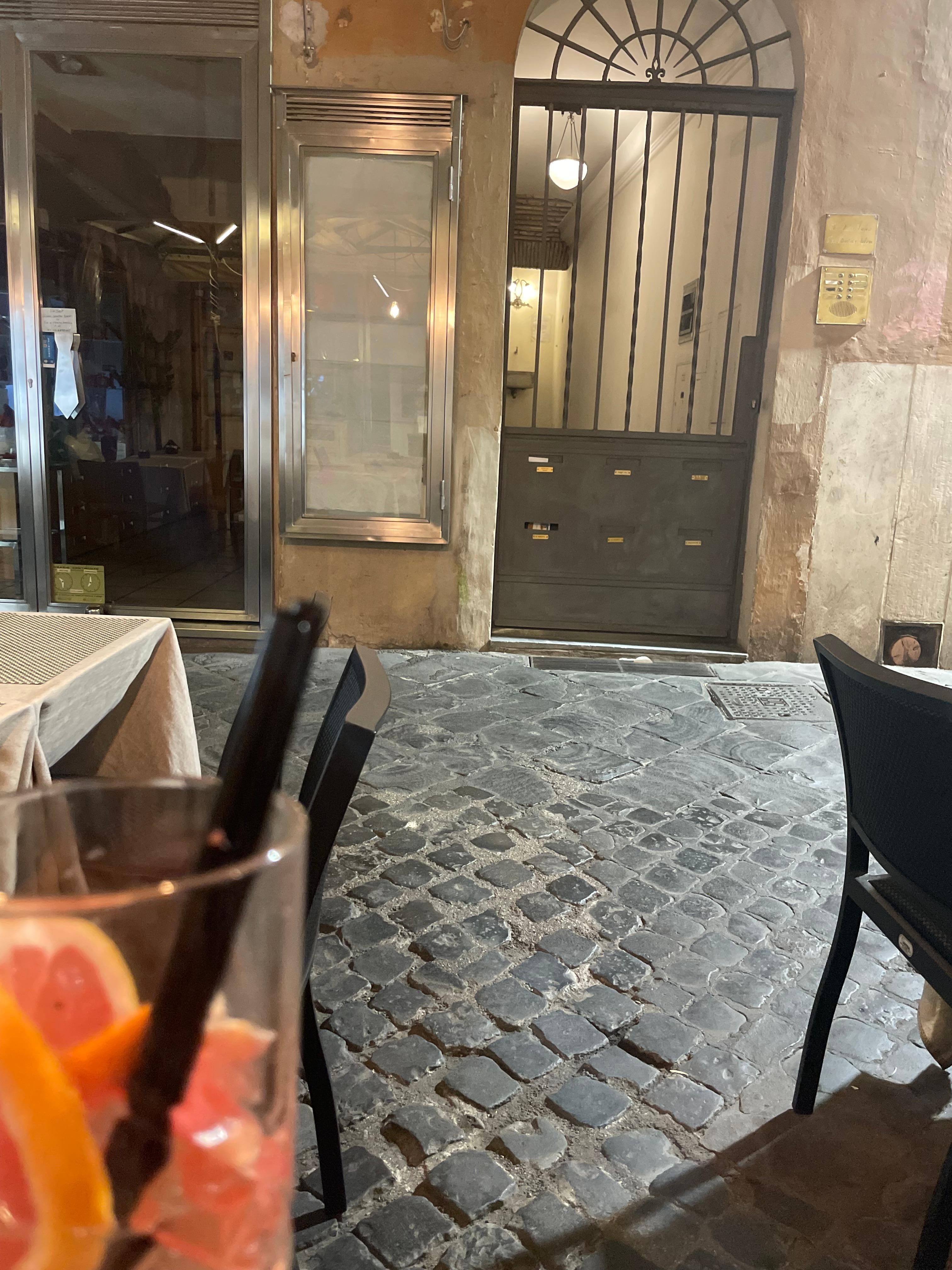 Having a drink at the restaurant right outside the door to the apartment.
