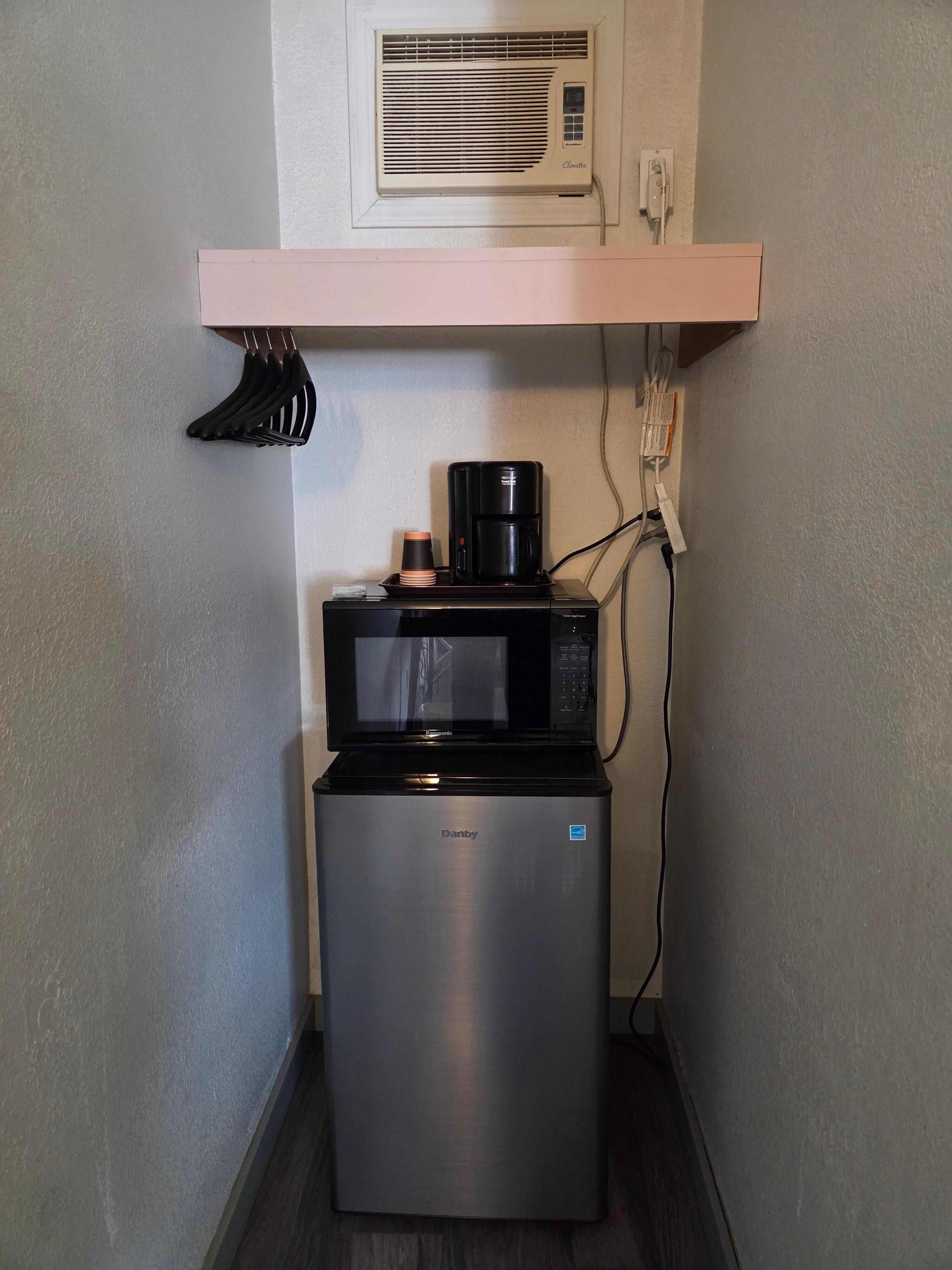 Extension cord for coffee pot/ fridge/ micro wave but no outlets for anything else. All these things were under the hanging rack so could not use it. AC at top of wall was dirty and could not reach it. Only 2 folding chairs to sit on.